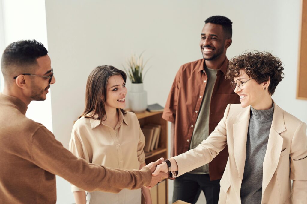 a business development services team shaking hands with client