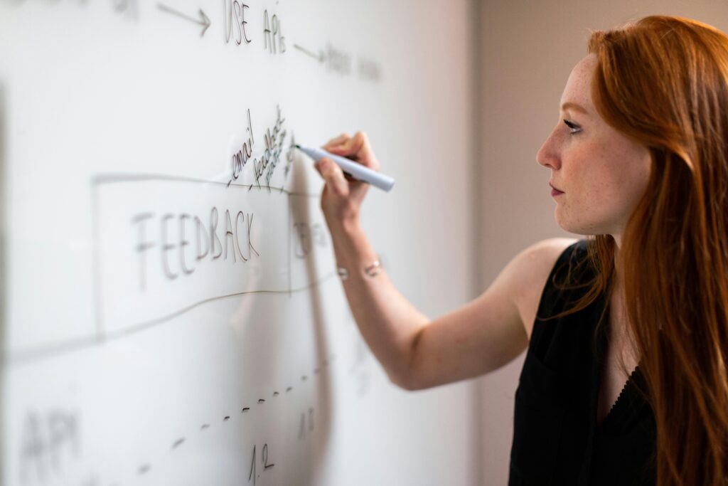 payments operations consulting team member writing on a whiteboard
